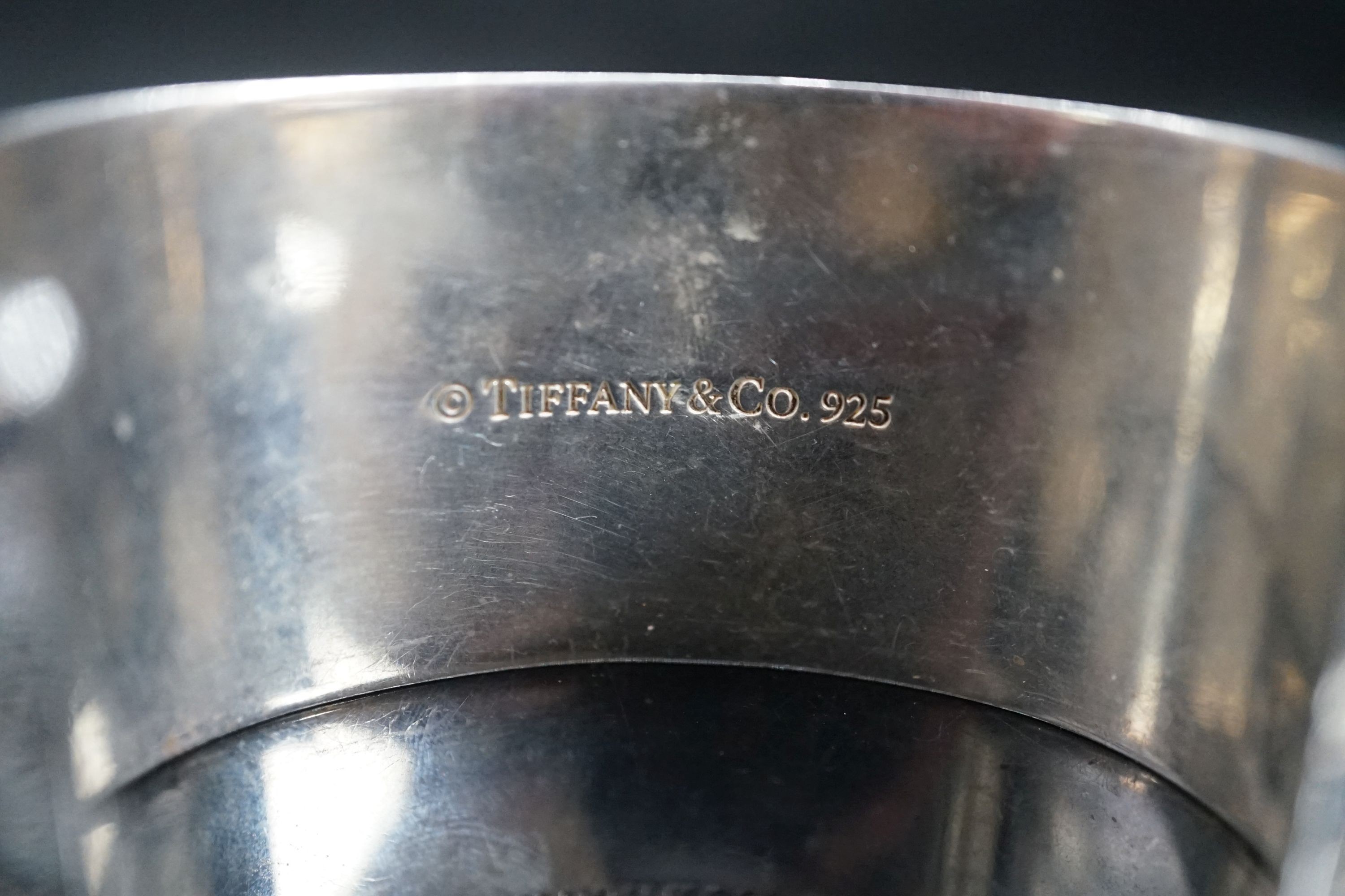 A Tiffany & Co 925 open bangle with engraved script, interior diameter approx. 69mm.